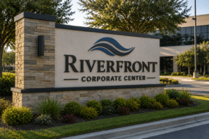 A high-end masonry monument sign with illuminated channel letters at the entrance of a Jacksonville corporate campus.
